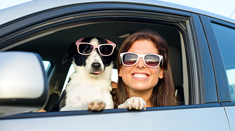 Woman smiling with her dog since because she knew how to simplify the car buying process